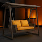 Wicker swing with yellow cushions in a dimly lit room